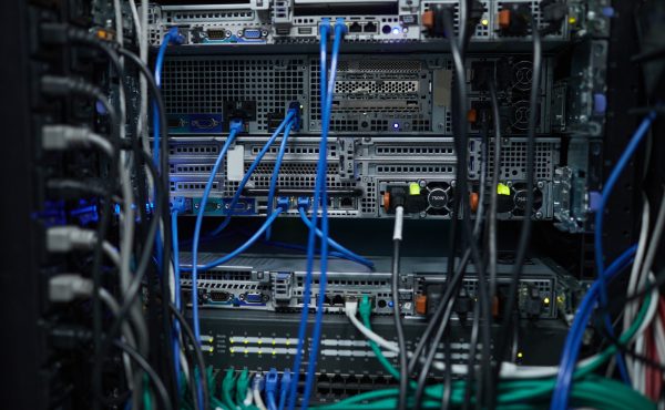 Background close up of server cabinet with cables and wires in data center, supercomputer concept, copy space