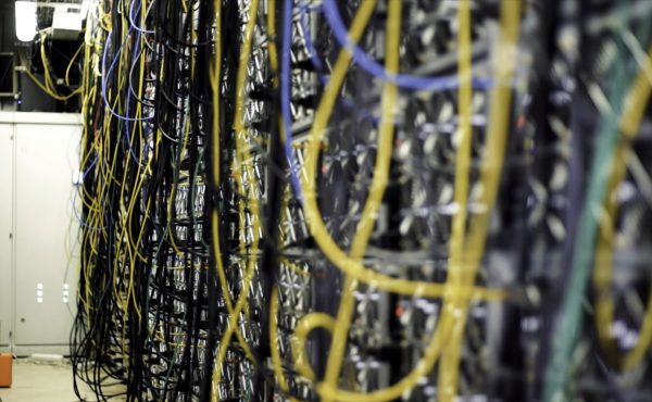 Multicolored data center wiring. Stock footage. Close-up of wall of computer data centers with lots of multicolored cables. Cooling systems for data center with bunch of cables.