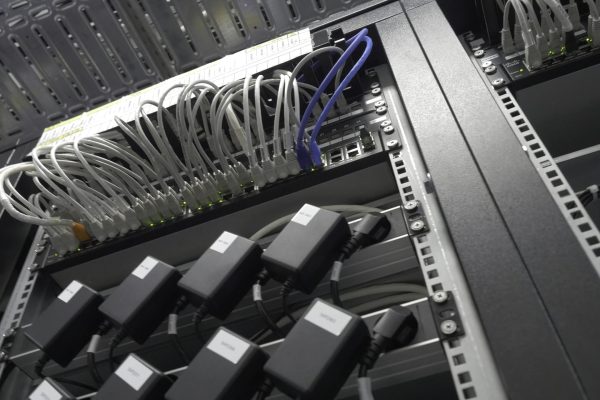Storage servers are located in the server room of the data center. Back of the server installed in the server room. Many cables are connected to a powerful computers 4K